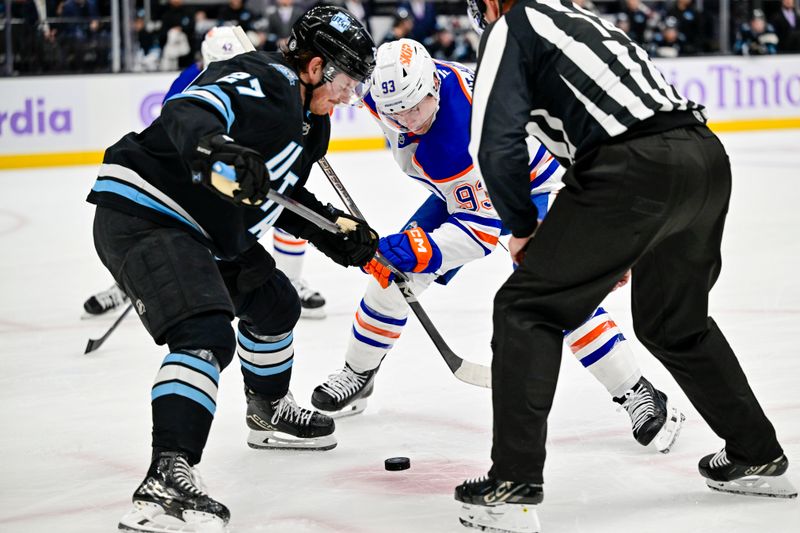 Nov 29, 2024; Salt Lake City, Utah, USA; Utah Hockey Club center Barrett Hayton (27) faces off against Edmonton Oilers center Ryan Nugent-Hopkins (93) at the Delta Center. Mandatory Credit: Christopher Creveling-Imagn Images