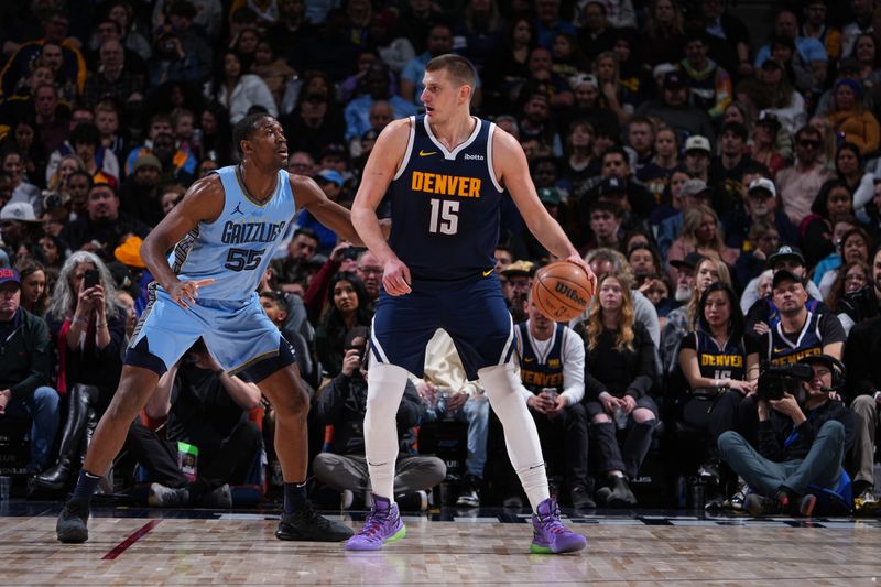 DENVER, CO - MARCH 25: Nikola Jokic #15 of the Denver Nuggets handles the ball during the game against the Memphis Grizzlies on March 25, 2024 at the Ball Arena in Denver, Colorado. NOTE TO USER: User expressly acknowledges and agrees that, by downloading and/or using this Photograph, user is consenting to the terms and conditions of the Getty Images License Agreement. Mandatory Copyright Notice: Copyright 2024 NBAE (Photo by Garrett Ellwood/NBAE via Getty Images)