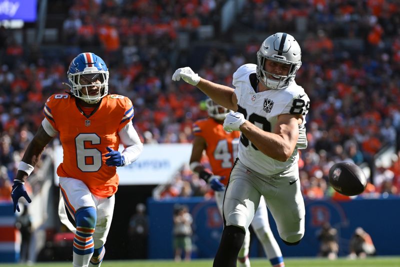 Las Vegas Raiders tight end Brock Bowers (89), defended by Denver Broncos safety P.J. Locke (6), is unable to catch the pass during the first half of an NFL football game, Sunday, Oct. 6, 2024, in Denver. (AP Photo/Geneva Heffernan)