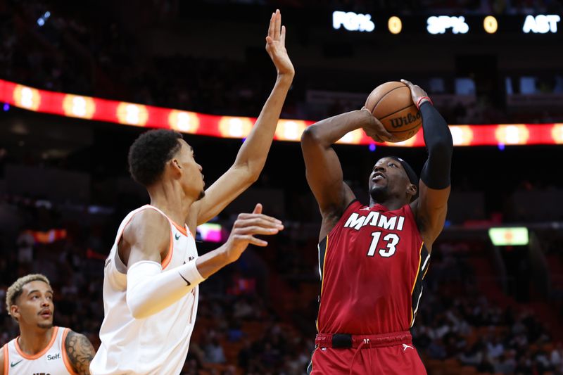 MIAMI, FLORIDA - FEBRUARY 07: Bam Adebayo #13 of the Miami Heat shoots the ball over Victor Wembanyama #1 of the San Antonio Spurs during the first quarter of the game at Kaseya Center on February 07, 2024 in Miami, Florida. NOTE TO USER: User expressly acknowledges and agrees that, by downloading and or using this photograph, User is consenting to the terms and conditions of the Getty Images License Agreement. (Photo by Megan Briggs/Getty Images)