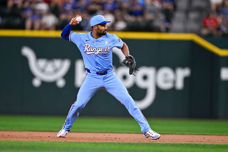 Sep 1, 2024; Arlington, Texas, USA; Texas Rangers second baseman Marcus Semien (2) throws to first base during the third inning at Globe Life Field. Mandatory Credit: Jerome Miron-USA TODAY Sports