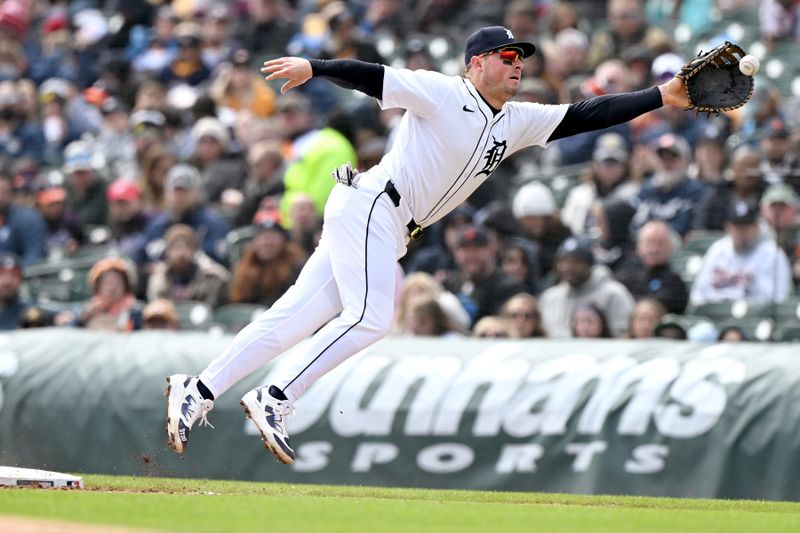Apr 6, 2025; Detroit, Michigan, USA;  Detroit Tigers first baseman Spencer Torkelson (20) gets pulled off the base by an errant throw by Tigers starting pitcher Jackson Jobe (not pictured) in the fourth inning at Comerica Park. Mandatory Credit: Lon Horwedel-Imagn Images
