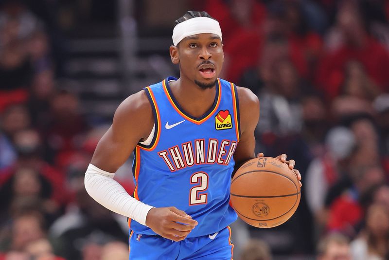 CHICAGO, ILLINOIS - OCTOBER 25: Shai Gilgeous-Alexander #2 of the Oklahoma City Thunder dribbles against the Chicago Bulls during the first half at the United Center on October 25, 2023 in Chicago, Illinois. NOTE TO USER: User expressly acknowledges and agrees that, by downloading and or using this photograph, User is consenting to the terms and conditions of the Getty Images License Agreement. (Photo by Michael Reaves/Getty Images)