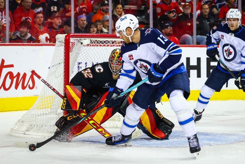 Oct 26, 2024; Calgary, Alberta, CAN; Winnipeg Jets center Gabriel Vilardi (13) controls the puck in front of Calgary Flames goaltender Dustin Wolf (32) during the third period at Scotiabank Saddledome. Mandatory Credit: Sergei Belski-Imagn Images