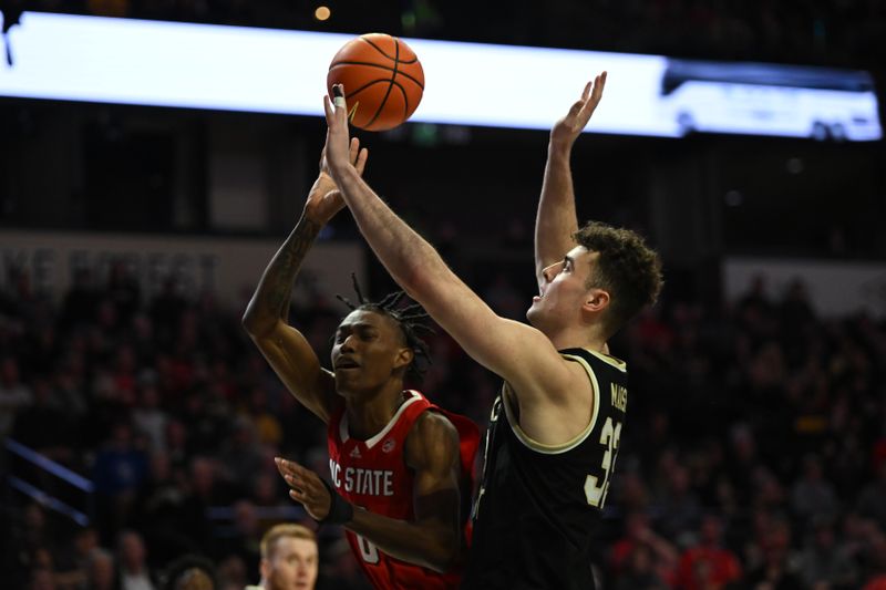 Jan 28, 2023; Winston-Salem, North Carolina, USA;   North Carolina State Wolfpack guard Terquavion Smith (0) throws up a runner against Wake Forest Demon Deacons forward Matthew Marsh (33) during the second half at Lawrence Joel Veterans Memorial Coliseum. Mandatory Credit: William Howard-USA TODAY Sports