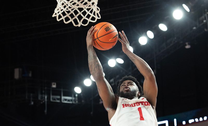 Jan 6, 2024; Houston, Texas, USA; Houston Cougars guard Jamal Shead (1) scores against West Virginia Mountaineers guard Kerr Kriisa (not pictured) in the second half at Fertitta Center. Mandatory Credit: Thomas Shea-USA TODAY Sports