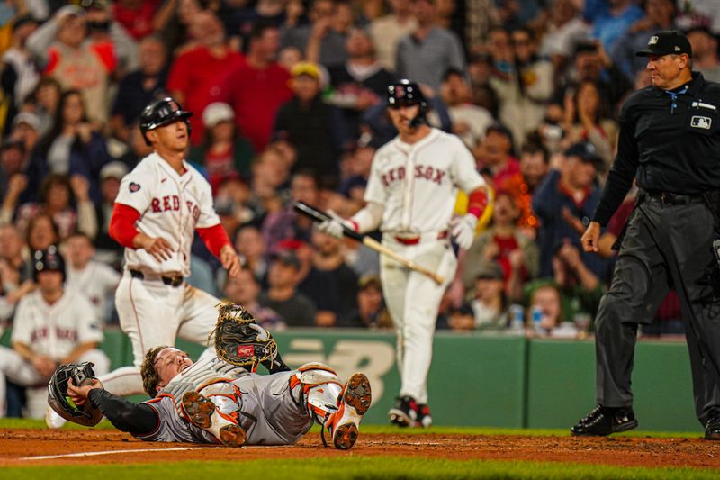 Sep 9, 2024; Boston, Massachusetts, USA; Boston Red Sox right fielder Rob Refsnyder (30) tagged out at home plate by Baltimore Orioles catcher Adley Rutschman (35) in the fifth inning at Fenway Park. Mandatory Credit: David Butler II-Imagn Images