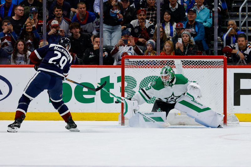 Mar 18, 2026; Denver, Colorado, USA; Colorado Avalanche center Nathan MacKinnon (29) shoots the puck wide of the net against Dallas Stars goaltender Jake Oettinger (29) in the shootout at Ball Arena. Mandatory Credit: Isaiah J. Downing-Imagn Images