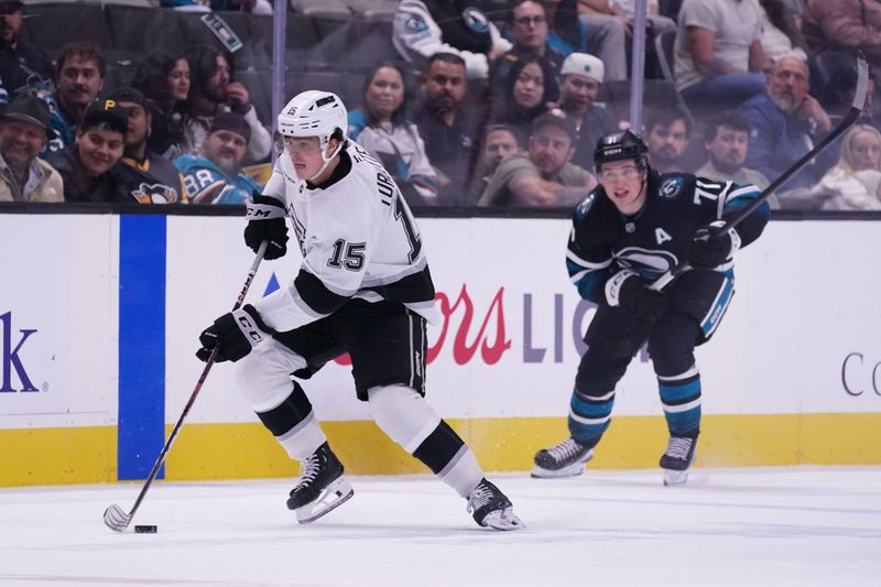 Oct 28, 2025; San Jose, California, USA; Los Angeles Kings center Alex Turcotte (15) advances the puck past San Jose Sharks center Macklin Celebrini (71) in the second period at SAP Center at San Jose. Mandatory Credit: David Gonzales-Imagn Images