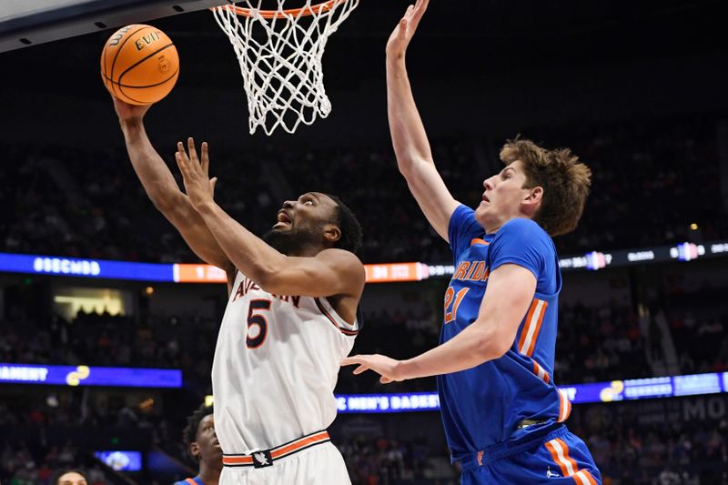 Mar 17, 2024; Nashville, TN, USA;  Auburn Tigers forward Chris Moore (5) shoots against Florida Gators forward Alex Condon (21) in the second half in the SEC Tournament championship game at Bridgestone Arena. Mandatory Credit: Steve Roberts-USA TODAY Sports