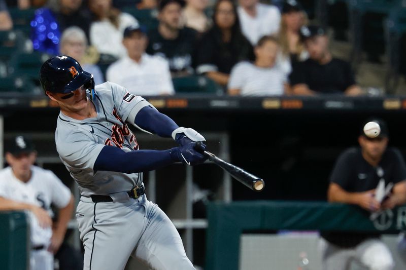 Aug 23, 2024; Chicago, Illinois, USA; Detroit Tigers catcher Dillon Dingler (38) hits an RBI-single against the Chicago White Sox during the second inning at Guaranteed Rate Field. Mandatory Credit: Kamil Krzaczynski-USA TODAY Sports