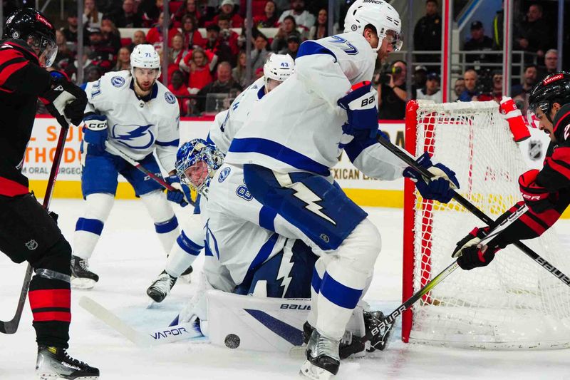 Nov 24, 2023; Raleigh, North Carolina, USA; Tampa Bay Lightning goaltender Andrei Vasilevskiy (88) stops the scoring attempt by Carolina Hurricanes center Seth Jarvis (24) during the first period at PNC Arena. Mandatory Credit: James Guillory-USA TODAY Sports