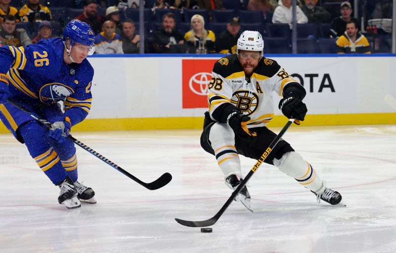 Jan 28, 2025; Buffalo, New York, USA;  Boston Bruins right wing David Pastrnak (88) looks to take a shot as Buffalo Sabres defenseman Rasmus Dahlin (26) defends during the first period at KeyBank Center. Mandatory Credit: Timothy T. Ludwig-Imagn Images