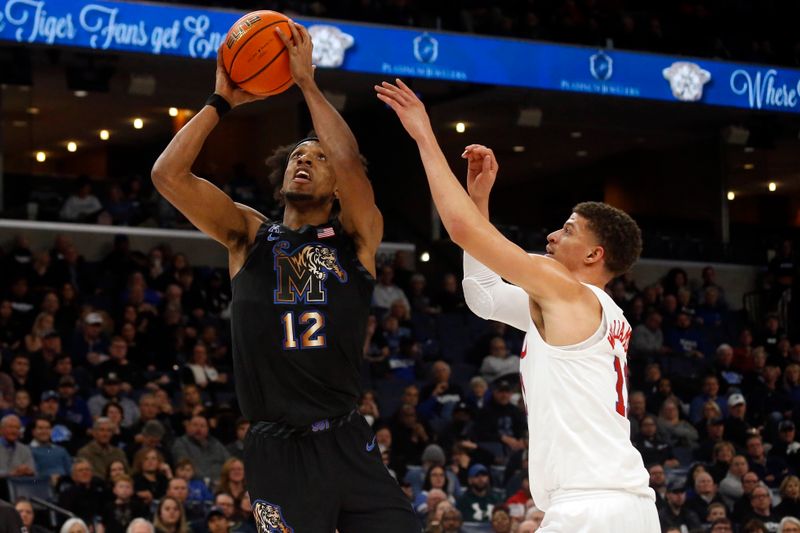 Jan 26, 2023; Memphis, Tennessee, USA; Memphis Tigers forward DeAndre Williams (12) drives to the basket as Southern Methodist Mustangs forward Samuell Williamson  (11) defends during the first half at FedExForum. Mandatory Credit: Petre Thomas-USA TODAY Sports