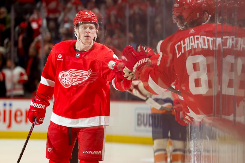 Feb 29, 2024; Detroit, Michigan, USA;  Detroit Red Wings defenseman Olli Maatta (2) receives congratulations from teammates after scoring in the third period against the New York Islanders at Little Caesars Arena. Mandatory Credit: Rick Osentoski-USA TODAY Sports