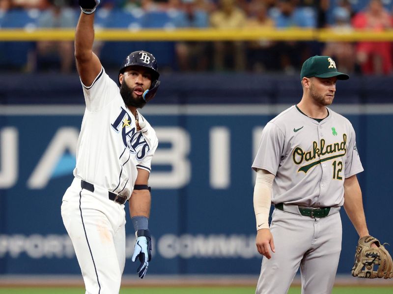 May 30, 2024; St. Petersburg, Florida, USA; Tampa Bay Rays outfielder Amed Rosario (10) celebrates after hitting a double as Oakland Athletics shortstop Max Schuemann (12) looks on during the second inning at Tropicana Field. Mandatory Credit: Kim Klement Neitzel-USA TODAY Sports