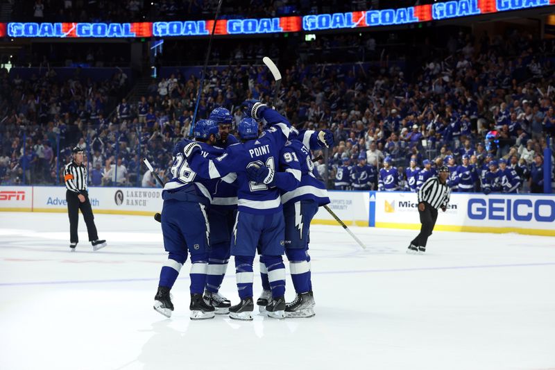 Oct 10, 2023; Tampa, Florida, USA; Tampa Bay Lightning right wing Nikita Kucherov (86) is congratulated by center Brayden Point (21),  center Steven Stamkos (91)  and defenseman Victor Hedman (77) after he scored a goal against the Nashville Predators during the first period at Amalie Arena. Mandatory Credit: Kim Klement Neitzel-USA TODAY Sports