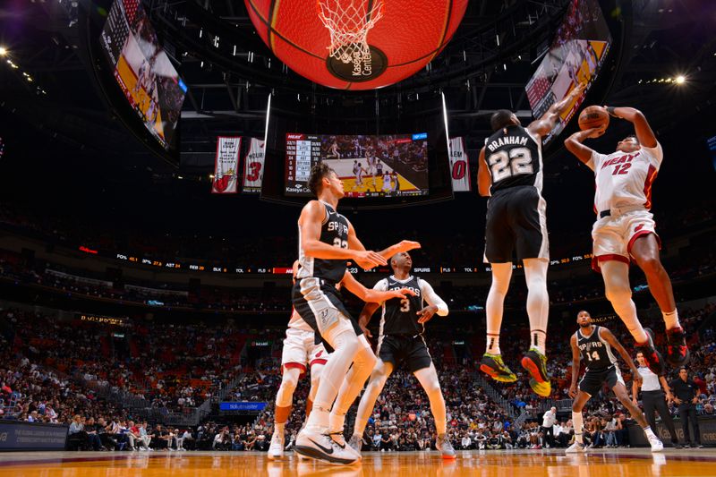 MIAMI, FL - OCTOBER 15: Dru Smith #12 of the Miami Heat drives to the basket during the game against the San Antonio Spurs during a NBA preseason game on October 15, 2024 at Kaseya Center in Miami, Florida. NOTE TO USER: User expressly acknowledges and agrees that, by downloading and or using this Photograph, user is consenting to the terms and conditions of the Getty Images License Agreement. Mandatory Copyright Notice: Copyright 2024 NBAE (Photo by Jesse D. Garrabrant/NBAE via Getty Images)