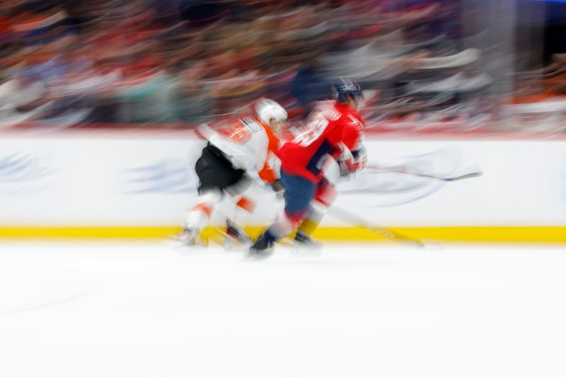 Mar 1, 2024; Washington, District of Columbia, USA; Philadelphia Flyers center Morgan Frost (48) and Washington Capitals center Michael Sgarbossa (23) chase the puck in the first period at Capital One Arena. Mandatory Credit: Geoff Burke-USA TODAY Sports