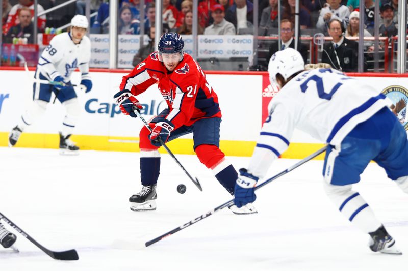 Mar 20, 2024; Washington, District of Columbia, USA; Washington Capitals center Connor McMichael (24) controls the puck as Toronto Maple Leafs left wing Matthew Knies (23) defends during the first period at Capital One Arena. Mandatory Credit: Amber Searls-USA TODAY Sports
