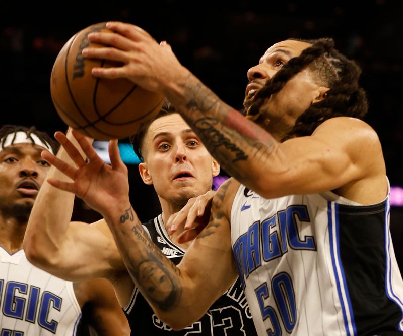 SAN ANTONIO, TX - MARCH 14:  Zach Collins #23 of the San Antonio Spurs prepares to block the shot of Cole Anthony #50 of the Orlando Magic in the second half at AT&T Center on March 14, 2023 in San Antonio, Texas. NOTE TO USER: User expressly acknowledges and agrees that, by downloading and or using this photograph, User is consenting to terms and conditions of the Getty Images License Agreement. (Photo by Ronald Cortes/Getty Images)