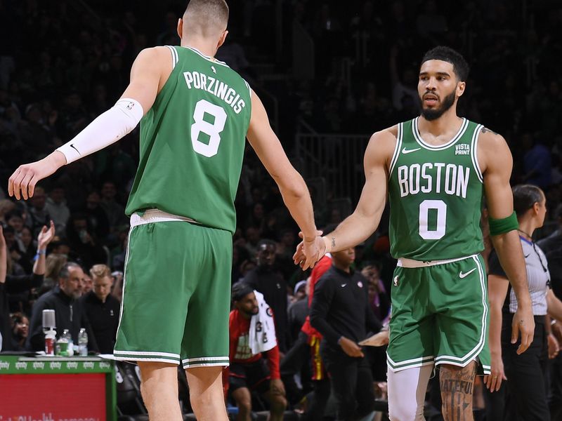 BOSTON, MA - FEBRUARY 7: Kristaps Porzingis #8 high fives Jayson Tatum #0 of the Boston Celtics during the game against the Atlanta Hawks on February 7, 2024 at the TD Garden in Boston, Massachusetts. NOTE TO USER: User expressly acknowledges and agrees that, by downloading and or using this photograph, User is consenting to the terms and conditions of the Getty Images License Agreement. Mandatory Copyright Notice: Copyright 2024 NBAE  (Photo by Brian Babineau/NBAE via Getty Images)