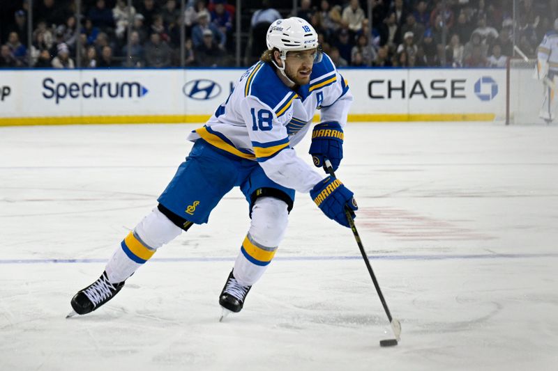 Nov 24, 2025; New York, New York, USA; St. Louis Blues center Robert Thomas (18) skates with the puck against the New York Rangers during the third period at Madison Square Garden. Mandatory Credit: Dennis Schneidler-Imagn Images