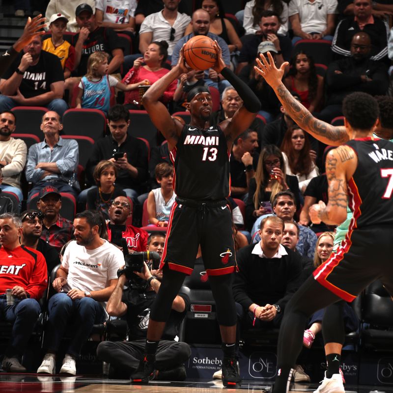 MIAMI, FL - March 23:  Bam Adebayo #13 of the Miami Heat looks to pass the ball during the game against the Charlotte Hornets on March 23, 2025 at Kaseya Center in Miami, Florida. NOTE TO USER: User expressly acknowledges and agrees that, by downloading and or using this Photograph, user is consenting to the terms and conditions of the Getty Images License Agreement. Mandatory Copyright Notice: Copyright 2025 NBAE (Photo by Issac Baldizon/NBAE via Getty Images)