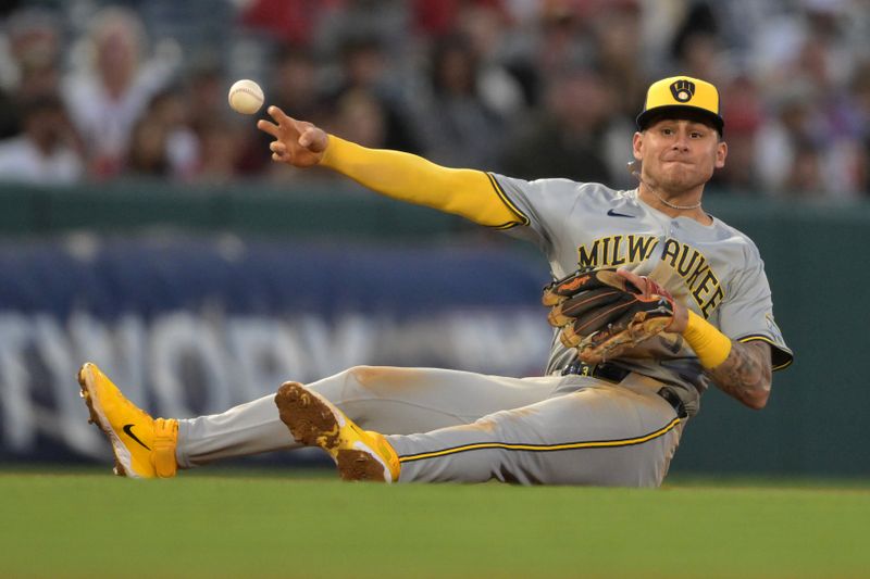 Jun 19, 2024; Anaheim, California, USA;  Milwaukee Brewers third baseman Joey Ortiz (3) makes a throw from the ground but can’t get Los Angeles Angels third baseman Luis Rengifo (2) out at first in the fifth inning at Angel Stadium. Mandatory Credit: Jayne Kamin-Oncea-USA TODAY Sports