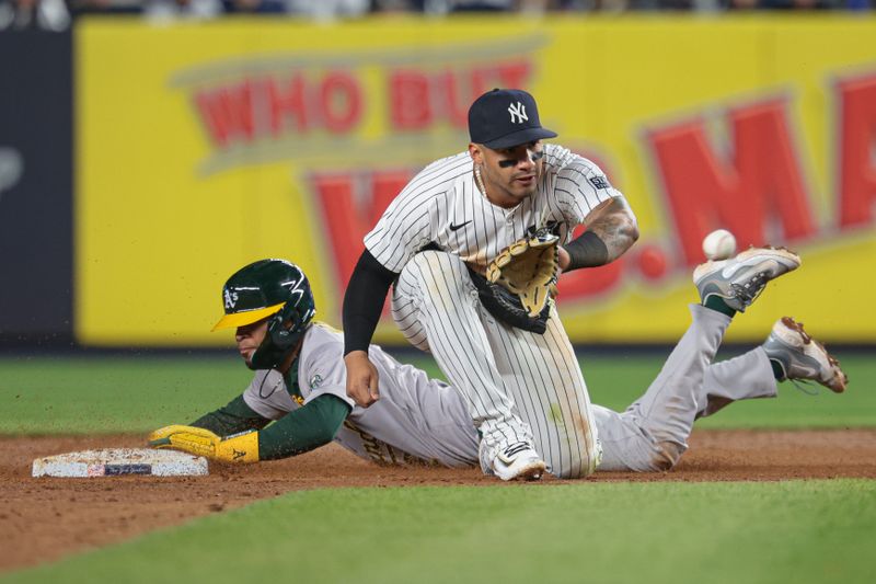 Apr 25, 2024; Bronx, New York, USA; Oakland Athletics third baseman Darell Hernaiz (2) steals second base before the throw to New York Yankees second baseman Gleyber Torres (25) during the fifth inning at Yankee Stadium. Mandatory Credit: Vincent Carchietta-USA TODAY Sports