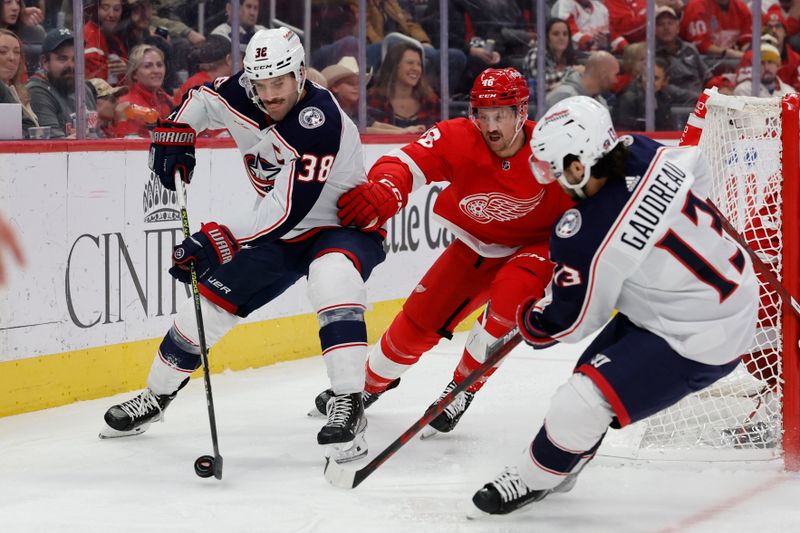 Nov 11, 2023; Detroit, Michigan, USA;  Columbus Blue Jackets center Boone Jenner (38) skates with the puck against Detroit Red Wings defenseman Jeff Petry (46) in the third period at Little Caesars Arena. Mandatory Credit: Rick Osentoski-USA TODAY Sports