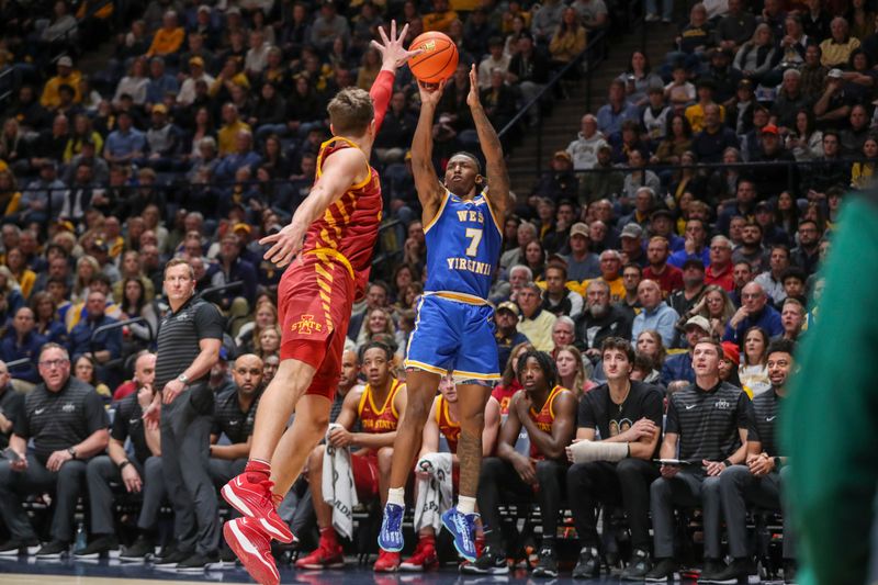Jan 18, 2025; Morgantown, West Virginia, USA; West Virginia Mountaineers guard Javon Small (7) shoots a three-point shot over Iowa State Cyclones forward Brandton Chatfield (33) during the first half at WVU Coliseum. Mandatory Credit: Ben Queen-Imagn Images