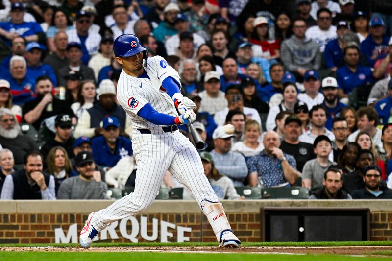 Apr 22, 2025; Chicago, Illinois, USA;  Chicago Cubs outfielder Seiya Suzuki (27) hits a two RBI single during the first inning against the bLos Angeles Dodgers at Wrigley Field. Mandatory Credit: Matt Marton-Imagn Images