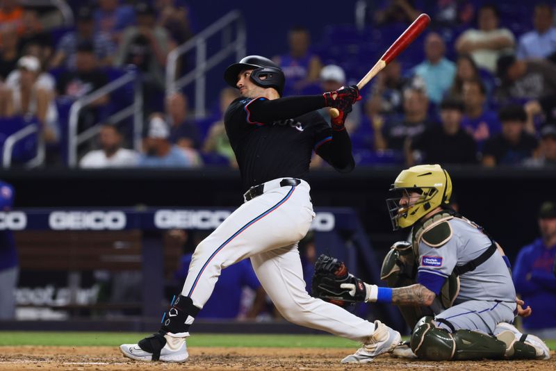 May 17, 2024; Miami, Florida, USA; Miami Marlins catcher Nick Fortes (4) hits a single against the New York Mets during the eighth inning at loanDepot Park. Mandatory Credit: Sam Navarro-USA TODAY Sports