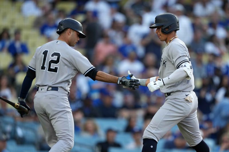 Jun 3, 2023; Los Angeles, California, USA; New York Yankees  left fielder Oswaldo Cabrera (95) celebrates with left fielder Isiah Kiner-Falefa (12) after hitting a home run in the ninth inning as Los Angeles Dodgers catcher Will Smith (16) watches at Dodger Stadium. Mandatory Credit: Kirby Lee-USA TODAY Sports