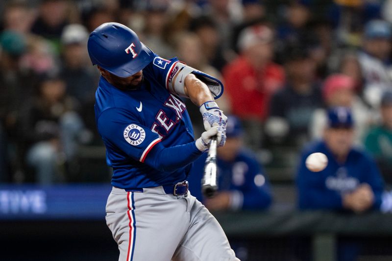 Jun 15, 2024; Seattle, Washington, USA; Texas Rangers second baseman Marcus Semien (2) hits a RBI-doulbe during the fifth inning against the Seattle Mariners at T-Mobile Park. Mandatory Credit: Stephen Brashear-USA TODAY Sports