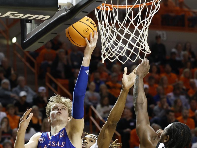 Feb 14, 2023; Stillwater, Oklahoma, USA; Kansas Jayhawks guard Gradey Dick (4) goes up for a basket in front of Oklahoma State Cowboys forward Tyreek Smith (23) during the second half at Gallagher-Iba Arena. Kansas won 87-76. Mandatory Credit: Alonzo Adams-USA TODAY Sports