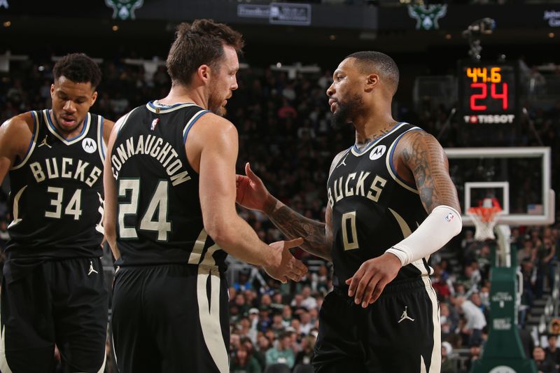 MILWAUKEE, WI - MARCH 14: Damian Lillard #0 and Pat Connaughton #24 of the Milwaukee Bucks high five during the game against the Philadelphia 76ers on March 14, 2024 at the Fiserv Forum Center in Milwaukee, Wisconsin. NOTE TO USER: User expressly acknowledges and agrees that, by downloading and or using this Photograph, user is consenting to the terms and conditions of the Getty Images License Agreement. Mandatory Copyright Notice: Copyright 2024 NBAE (Photo by Gary Dineen/NBAE via Getty Images).