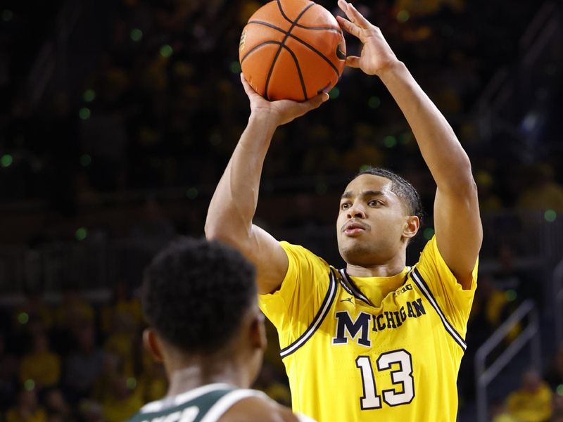 Feb 18, 2023; Ann Arbor, Michigan, USA;  Michigan Wolverines guard Jett Howard (13) shoots the ball over Michigan State Spartans guard Tyson Walker (2) in the first half at Crisler Center. Mandatory Credit: Rick Osentoski-USA TODAY Sports