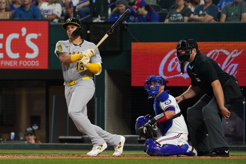 Apr 28, 2025; Arlington, Texas, USA; Athletics third baseman Gio Urshela (13) hits a double against the Texas Rangers during the fifth inning at Globe Life Field. Mandatory Credit: Raymond Carlin III-Imagn Images