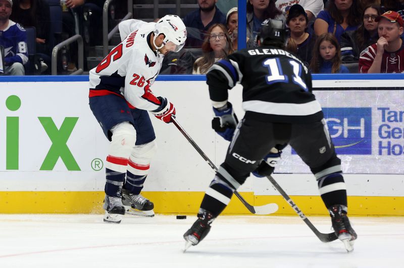 Oct 26, 2024; Tampa, Florida, USA; Washington Capitals center Nic Dowd (26) skates with the puck as Tampa Bay Lightning center Luke Glendening (11) defends during the second period at Amalie Arena. Mandatory Credit: Kim Klement Neitzel-Imagn Images