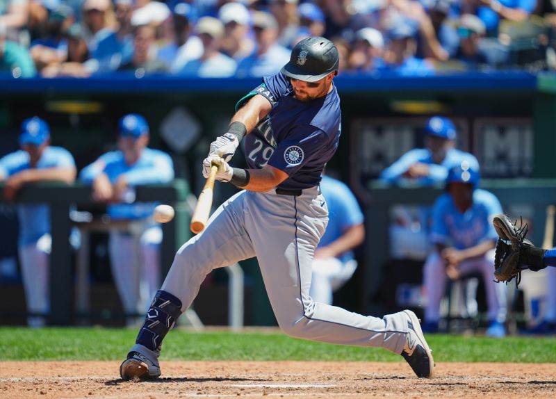 Jun 9, 2024; Kansas City, Missouri, USA; Seattle Mariners designated hitter Cal Raleigh (29) hits a single during the seventh inning against the Kansas City Royals at Kauffman Stadium. Mandatory Credit: Jay Biggerstaff-USA TODAY Sports