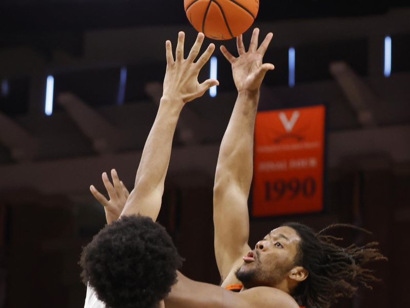 Feb 1, 2025; Charlottesville, Virginia, USA; Virginia Tech Hokies forward Mylyjael Poteat (34) shoots the ball as Virginia Cavaliers forward Jacob Cofie (5) defends during the first half at John Paul Jones Arena. Mandatory Credit: Amber Searls-Imagn Images