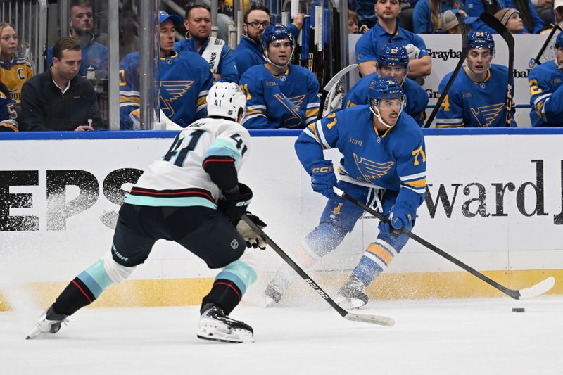 Nov 8, 2025; St. Louis, Missouri, USA; Seattle Kraken defenseman Ryker Evans (41) defends against the St. Louis Blues right wing Mathieu Joseph (71) in the second period at Enterprise Center. Mandatory Credit: Joe Puetz-Imagn Images