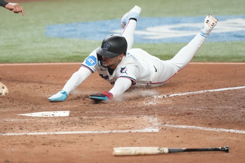 Sep 11, 2025; Miami, Florida, USA;  Miami Marlins center fielder Victor Mesa Jr. (10) scores a run in the eighth inning against the Washington Nationals at loanDepot Park. Mandatory Credit: Jim Rassol-Imagn Images