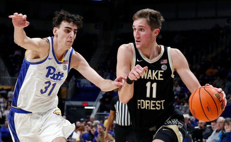 Jan 25, 2023; Pittsburgh, Pennsylvania, USA;  Wake Forest Demon Deacons forward Andrew Carr (11) drives to the basket against Pittsburgh Panthers forward Jorge Diaz Graham (31) during the first half at the Petersen Events Center. Mandatory Credit: Charles LeClaire-USA TODAY Sports