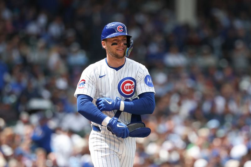 May 17, 2025; Chicago, Illinois, USA; Chicago Cubs second baseman Nico Hoerner (2) walks to first base during the second inning of a baseball game against the Chicago White Sox at Wrigley Field. Mandatory Credit: Kamil Krzaczynski-Imagn Images