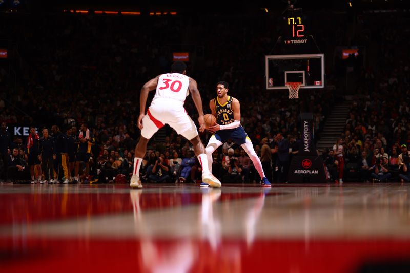 TORONTO, CANADA - APRIL 9:  Tyrese Haliburton #0 of the Indiana Pacers handles the ball during the game  on April 9, 2024 at the Scotiabank Arena in Toronto, Ontario, Canada.  NOTE TO USER: User expressly acknowledges and agrees that, by downloading and or using this Photograph, user is consenting to the terms and conditions of the Getty Images License Agreement.  Mandatory Copyright Notice: Copyright 2024 NBAE (Photo by Vaughn Ridley/NBAE via Getty Images)