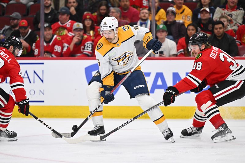 Apr 12, 2024; Chicago, Illinois, USA; Nashville Predators forward Filip Forsberg (9) controls the puck in the third period while being defended by Chicago Blackhawks defenseman Ethan Del Mastro (38) at United Center. Mandatory Credit: Jamie Sabau-USA TODAY Sports