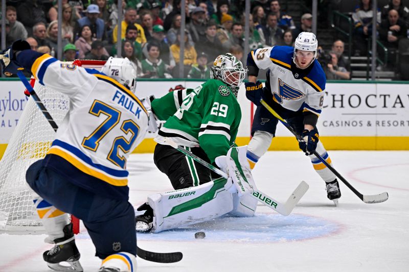 Dec 14, 2024; Dallas, Texas, USA; Dallas Stars goaltender Jake Oettinger (29) stops a shot by St. Louis Blues defenseman Justin Faulk (72) as left wing Jake Neighbours (63) looks for the rebound during the first period at American Airlines Center. Mandatory Credit: Jerome Miron-Imagn Images